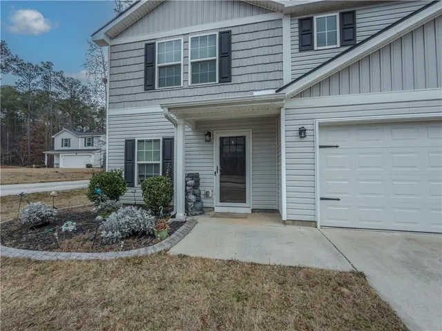 a view of a house with a small yard and plants