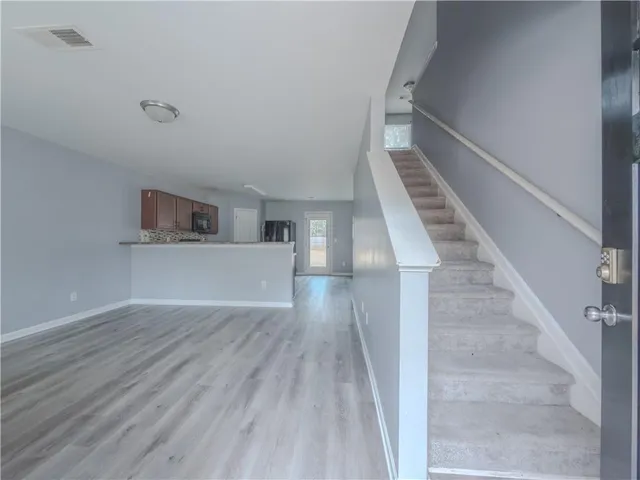 a view of entryway and hall with wooden floor