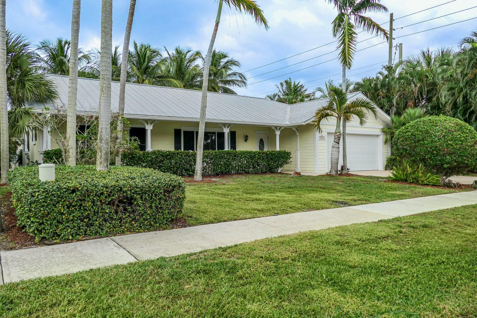 18014 Perigon Way Jupiter, FL 33458 - Photo 2 of 35 a front view of a house with a garden