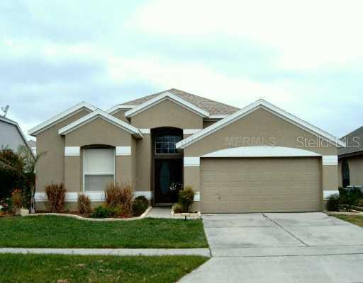 2712 River Ridge Drive Orlando, FL 32825 - Photo 1 of 1 a front view of a house with a yard and garage
