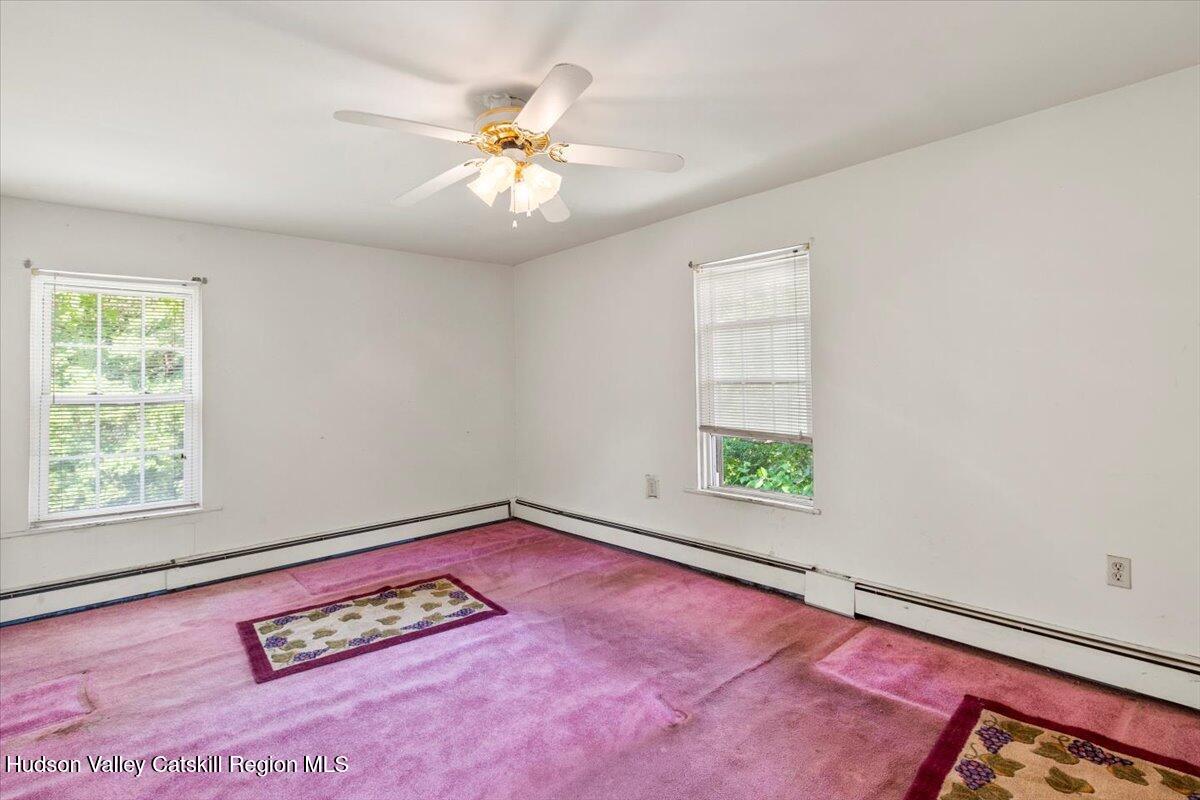 7 Grove Street Cairo, NY 12413 - Photo 17 of 35 an empty room with windows and ceiling fan