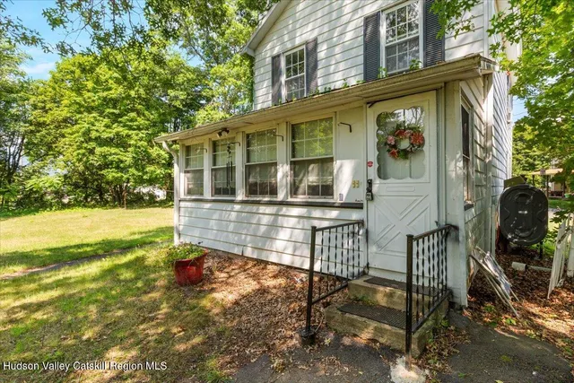 a view of a house with backyard and sitting area