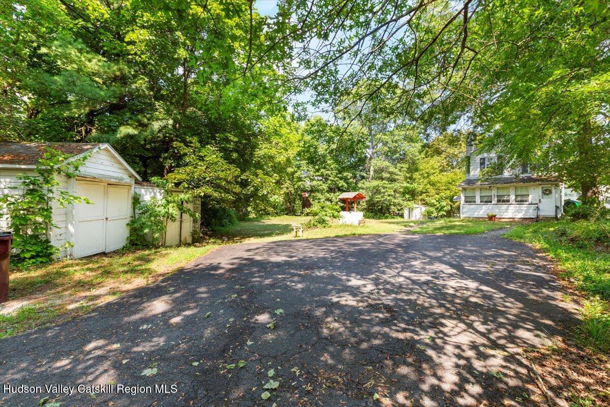 7 Grove Street Cairo, NY 12413 - Photo 24 of 35 a backyard of a house with large trees and plants