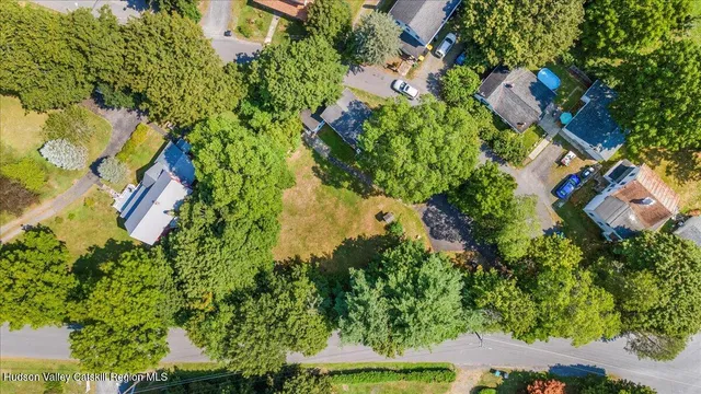 an aerial view of residential house with outdoor space and trees all around