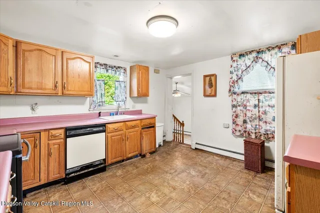 a spacious bathroom with a double vanity sink a mirror and a bathtub