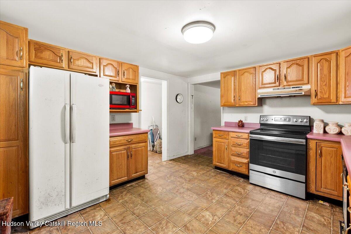 7 Grove Street Cairo, NY 12413 - Photo 8 of 35 a kitchen with stainless steel appliances a refrigerator and a stove