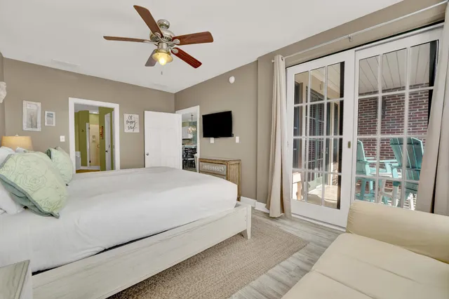 a bedroom with a large bed and a large window