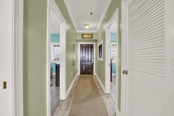 a view of hallway with wooden floor
