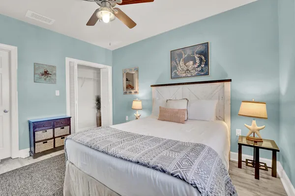 a bedroom with a bed and a lamp on table