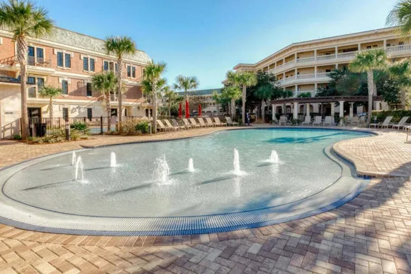 a view of a swimming pool with outdoor seating