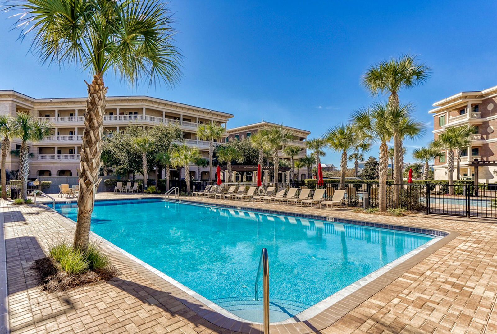 10343 East County Highway 30A, Unit 412B Seacrest, FL 32413 - Photo 28 of 39 a view of a swimming pool with a lounge chair and palm trees
