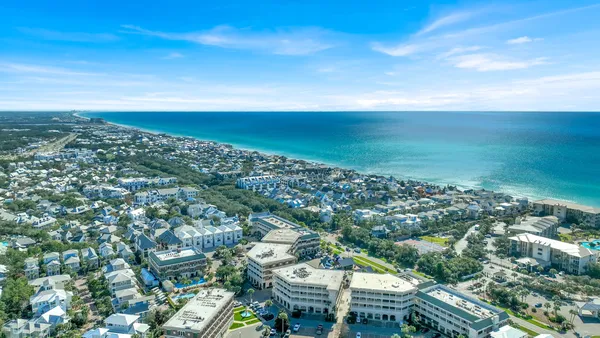 an aerial view of residential building and ocean