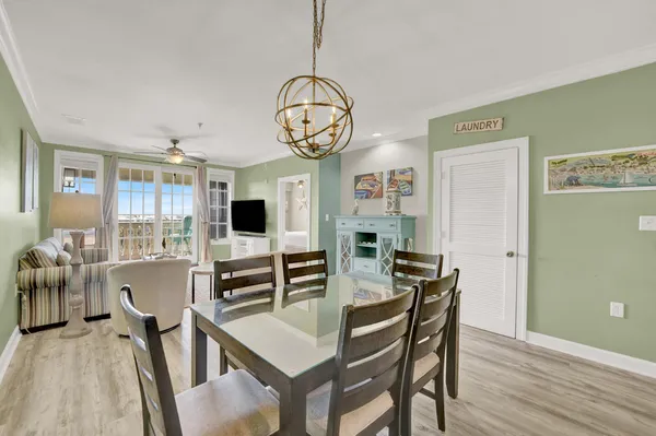 a view of a dining room with furniture and a large window