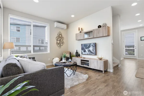 a living room with furniture and floor to ceiling windows