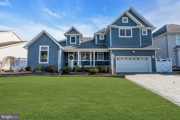 a front view of a house with a yard table and chairs