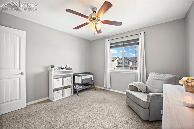 7148 Red Cardinal Loop Colorado Springs, CO 80908 - Photo 35 of 50 Sitting room featuring a ceiling fan, carpet, and baseboards