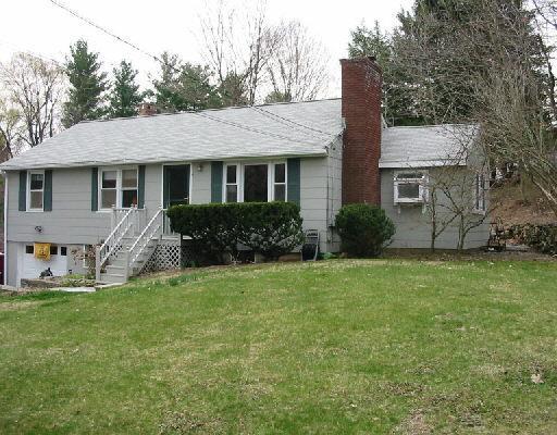 55 Ramapoo Road Ridgefield, CT 06877 - Photo 1 of 1 a front view of house with yard and trees in the background