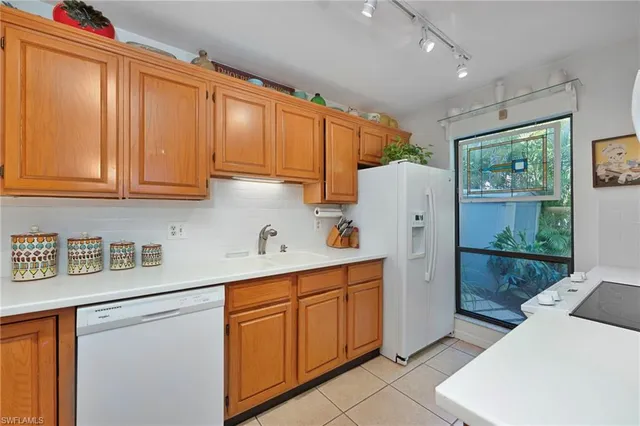 a kitchen with stainless steel appliances granite countertop a refrigerator sink and cabinets