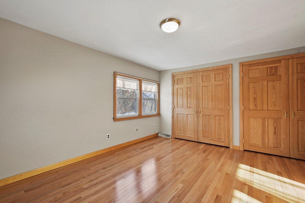 2 Market Street Billerica, MA 01821 - Photo 27 of 34 an empty room with wooden floor and windows