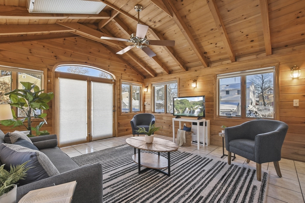 2 Market Street Billerica, MA 01821 - Photo 9 of 34 a living room with furniture a flat screen tv and a large window