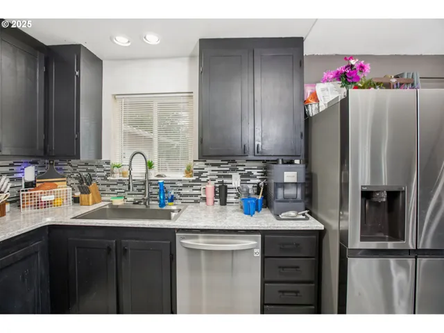a kitchen with refrigerator and sink