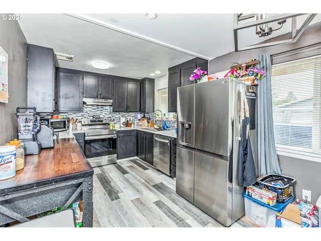 a kitchen view with counter top space and refrigerator
