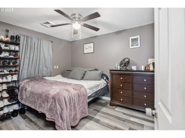 a bedroom with a bed and a bookshelf