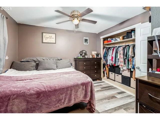 a bedroom with a bed cabinets and window