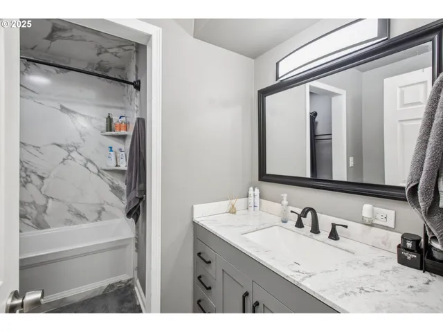 a bathroom with a granite countertop sink mirror and vanity