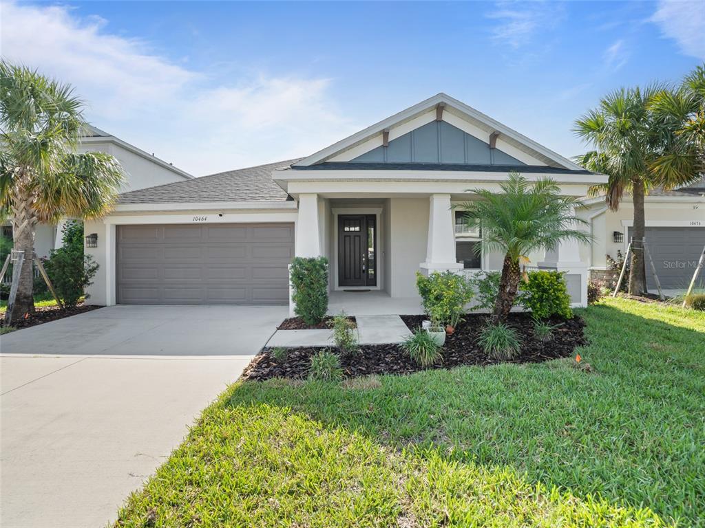10464 Tranquil Mdw Loop Riverview, FL 33569 - Photo 1 of 1 a front view of a house with a yard and potted plants