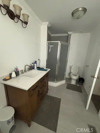 a bedroom with bed chair and a large mirror