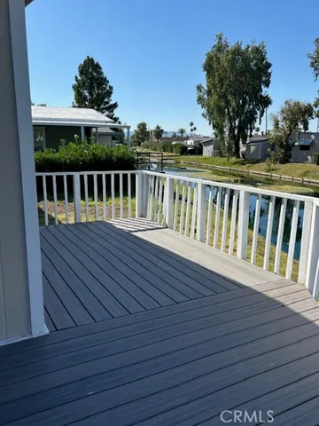 a view of balcony with wooden floor and fence