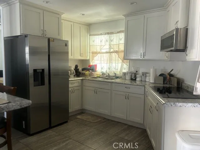 a kitchen with a refrigerator sink and microwave