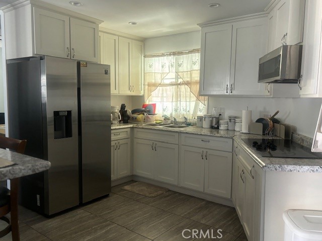 578 Channel Way Needles, CA 92363 - Photo 6 of 20 a kitchen with a refrigerator sink and microwave