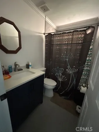 a bathroom with a sink vanity mirror and toilet