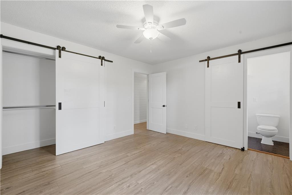 125 Childers Road Canton, GA 30115 - Photo 35 of 48 a view of a room with wooden floor and a ceiling fan