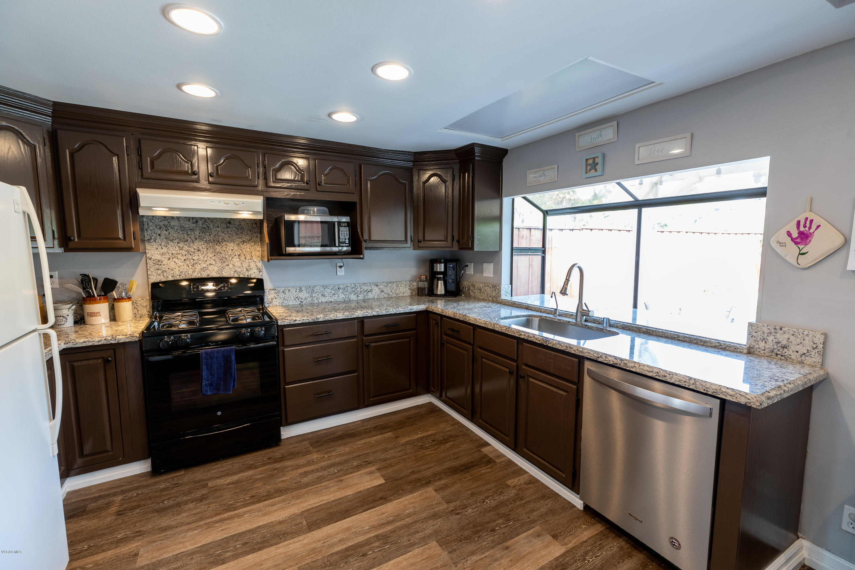 13635 Gunsmoke Road Moorpark, CA 93021 - Photo 13 of 34 a kitchen with stainless steel appliances granite countertop a stove a sink and a refrigerator