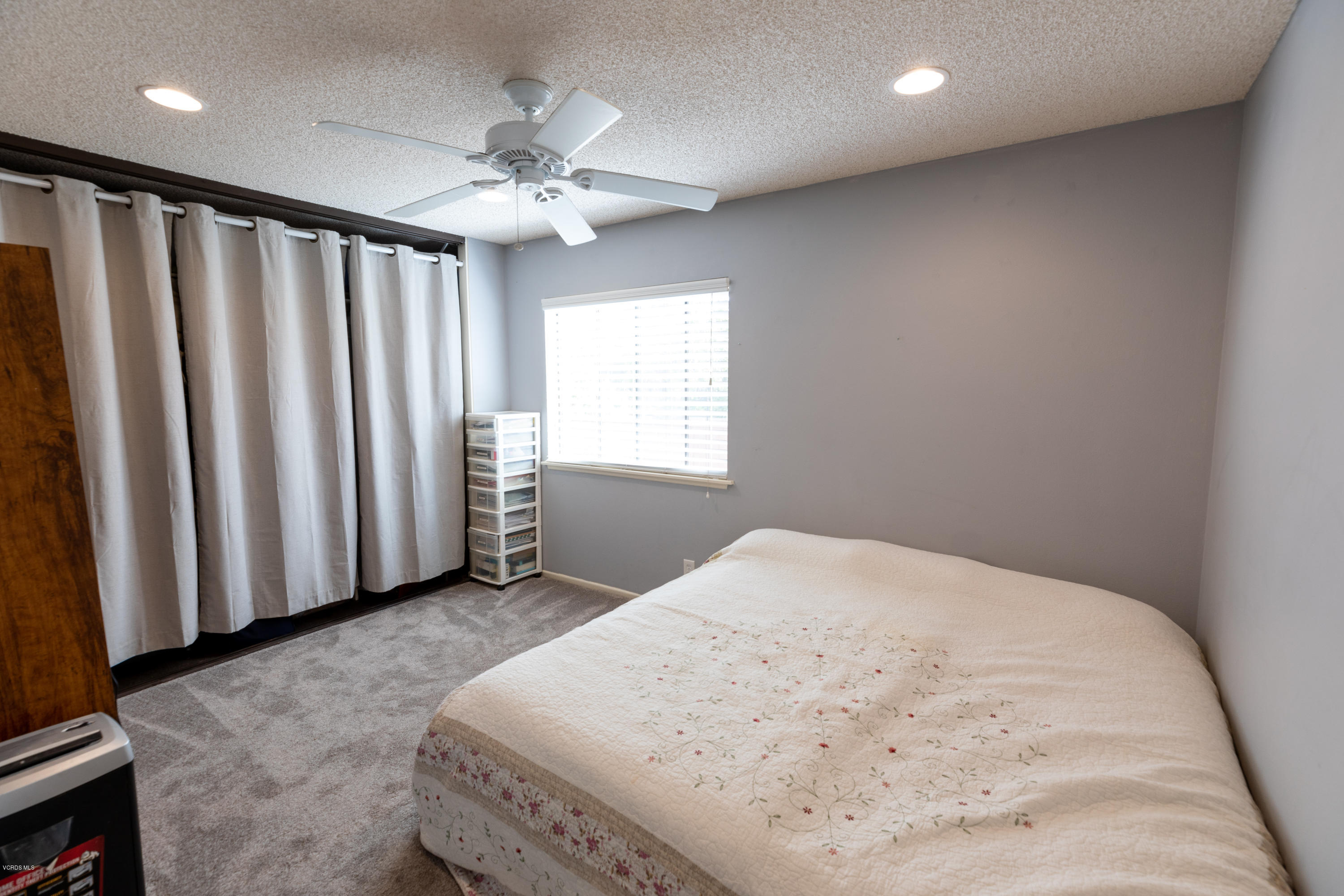13635 Gunsmoke Road Moorpark, CA 93021 - Photo 24 of 34 a bedroom with a bed and a chandelier