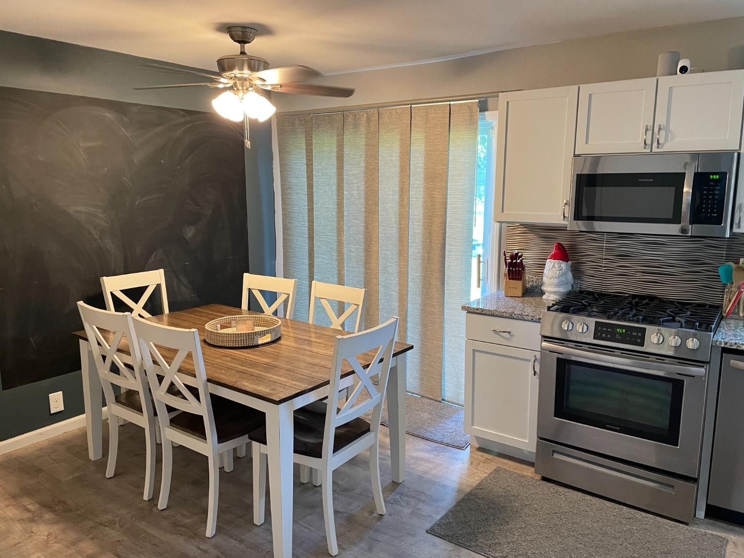 746-1 Governor Road Valparaiso, IN 46385 - Photo 5 of 13 a kitchen with stainless steel appliances kitchen island granite countertop a dining table and chairs