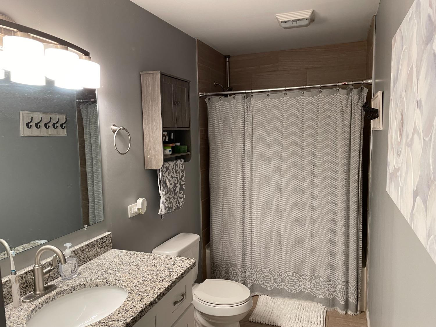 746-1 Governor Road Valparaiso, IN 46385 - Photo 6 of 13 a bathroom with a granite countertop sink toilet and shower