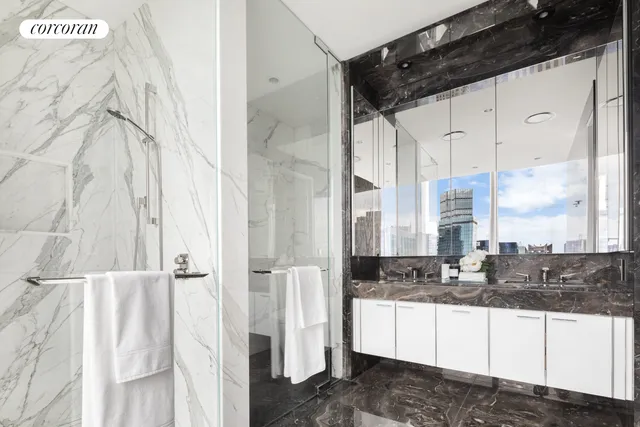 a bedroom with furniture and a large window