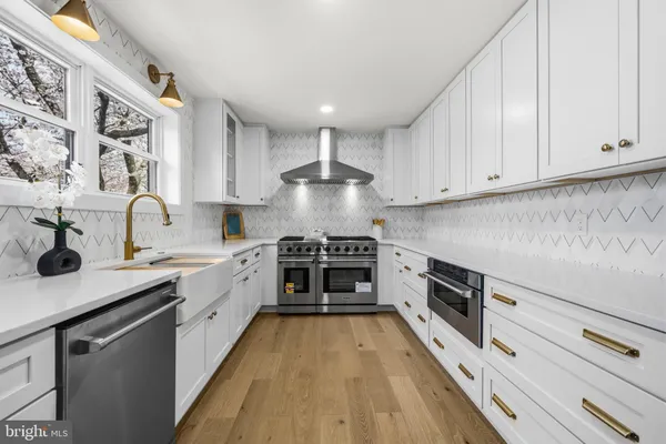 a kitchen with stainless steel appliances a stove sink and cabinets