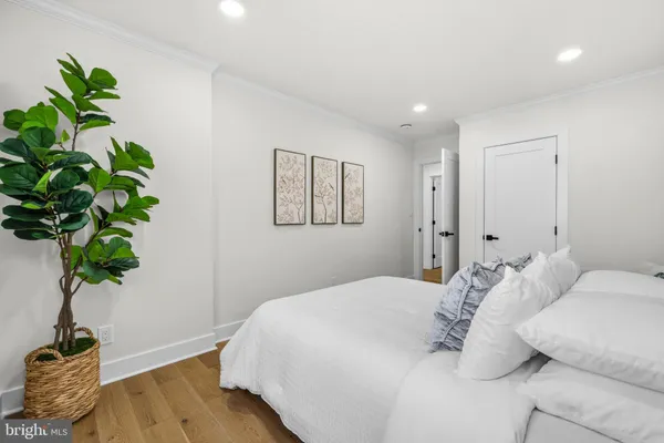 a bedroom with a bed and a potted plant