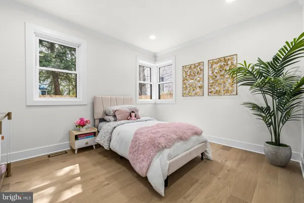 a bedroom with a bed and a potted plant