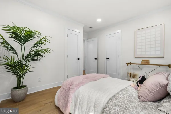 a bedroom with a bed a table and a window