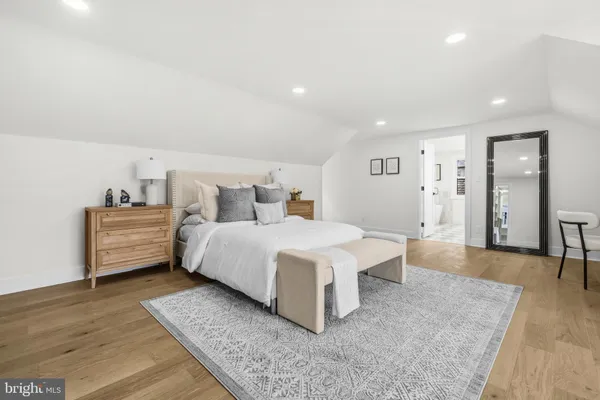 a spacious bedroom with a bed and window