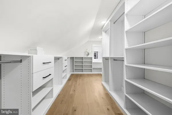 a living room with furniture a wooden floor and white walls
