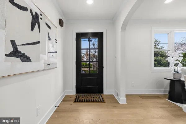 a view of entryway with a window and wooden floor