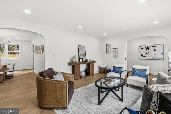 a living room with furniture a rug and a table