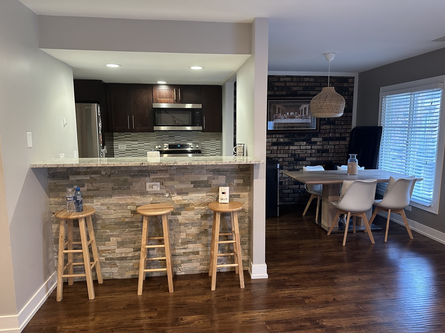 9830 Sayre Avenue, Unit 13 Chicago Ridge, IL 60415 - Photo 17 of 34 a kitchen with stainless steel appliances granite countertop a stove top oven a sink and a dining table